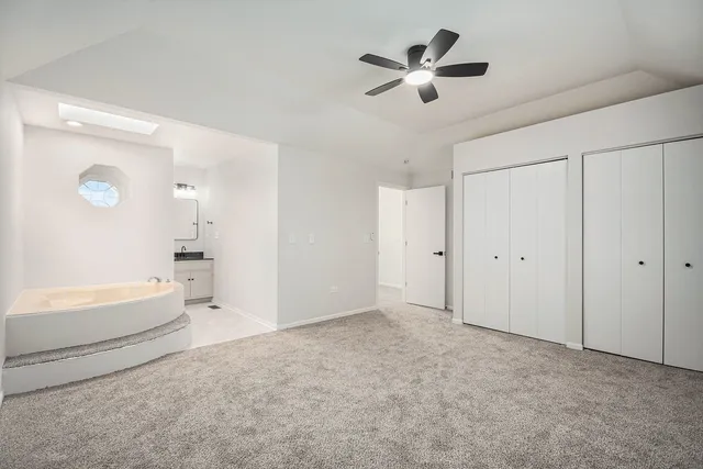 a view of empty room with ceiling fan