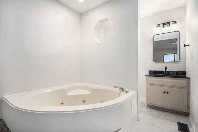 a white bath tub sitting in a bathroom