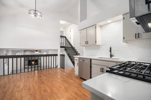 a kitchen with stainless steel appliances a stove a sink and a refrigerator