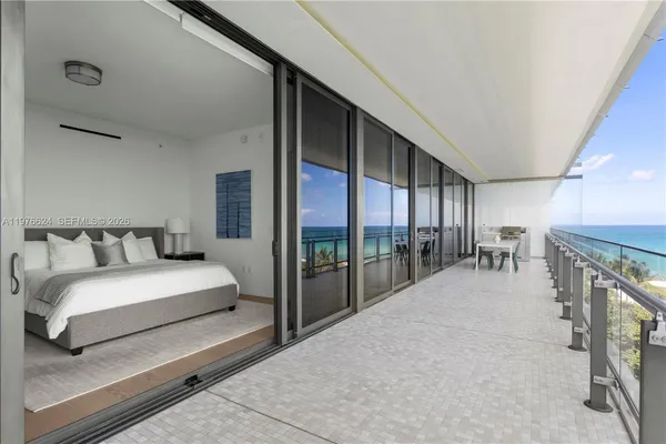 a spacious bedroom with a large bed and a chandelier