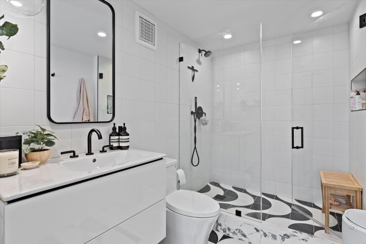949 West Madison Street, Unit 406 Chicago, IL 60607 - Photo 13 of 16 a bathroom with a sink toilet and shower