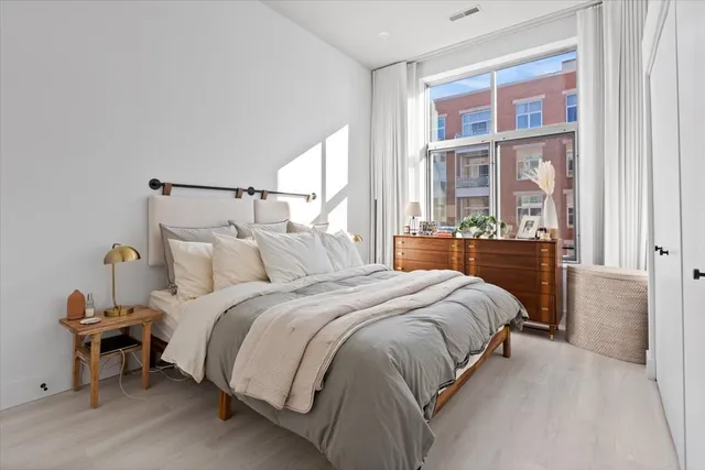 a bedroom with a bed and a window