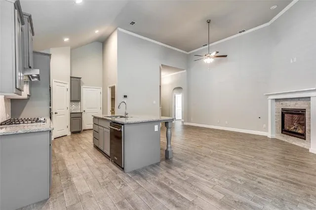 a kitchen with stainless steel appliances granite countertop a stove and a refrigerator