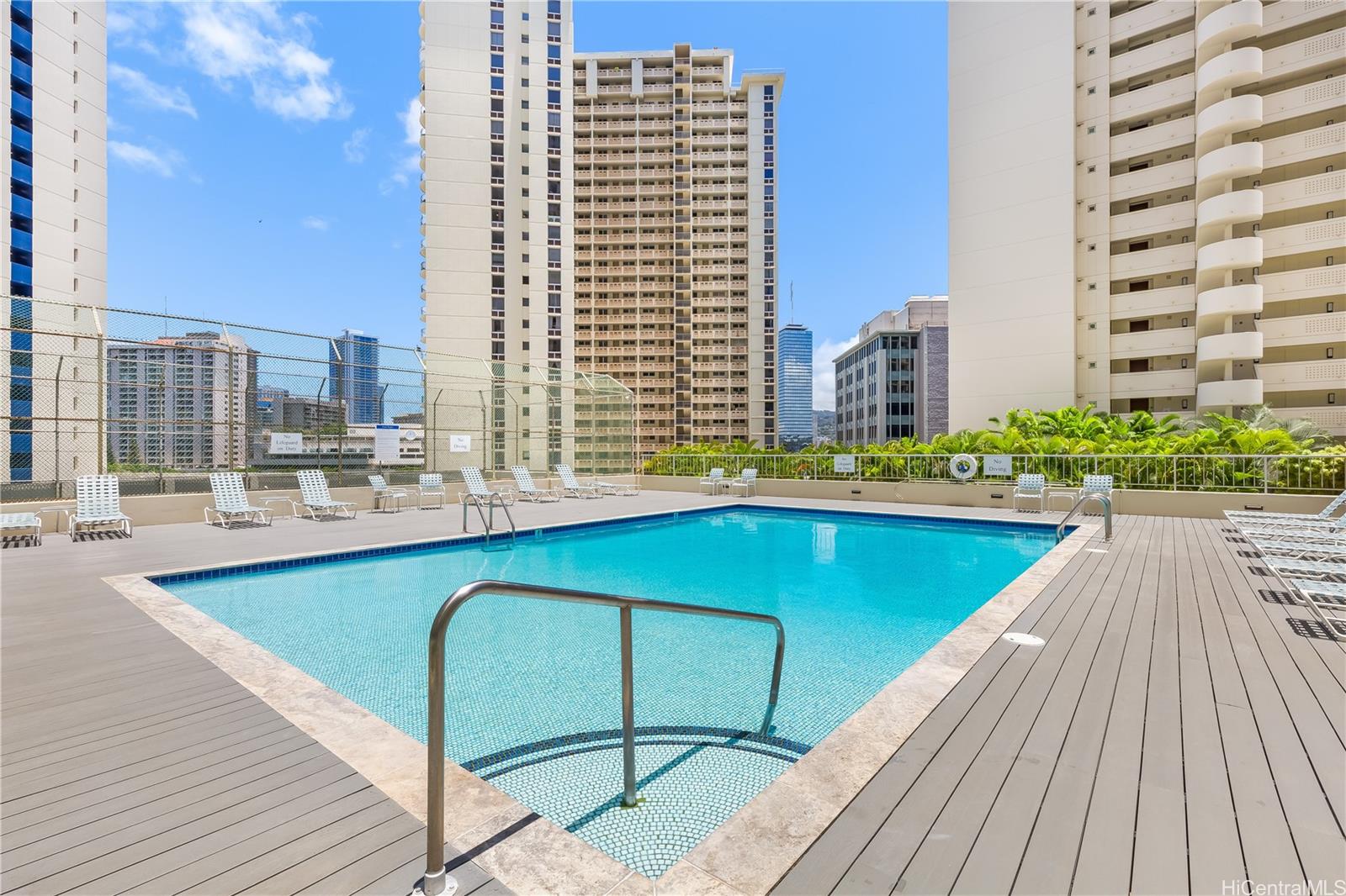 469 Ena Road, Unit 2102 Honolulu, HI 96815 - Photo 3 of 15 a swimming pool with outdoor seating and yard