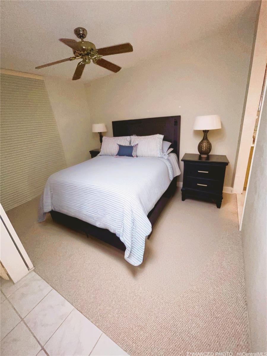469 Ena Road, Unit 2102 Honolulu, HI 96815 - Photo 10 of 15 a bedroom with a bed and a night stand