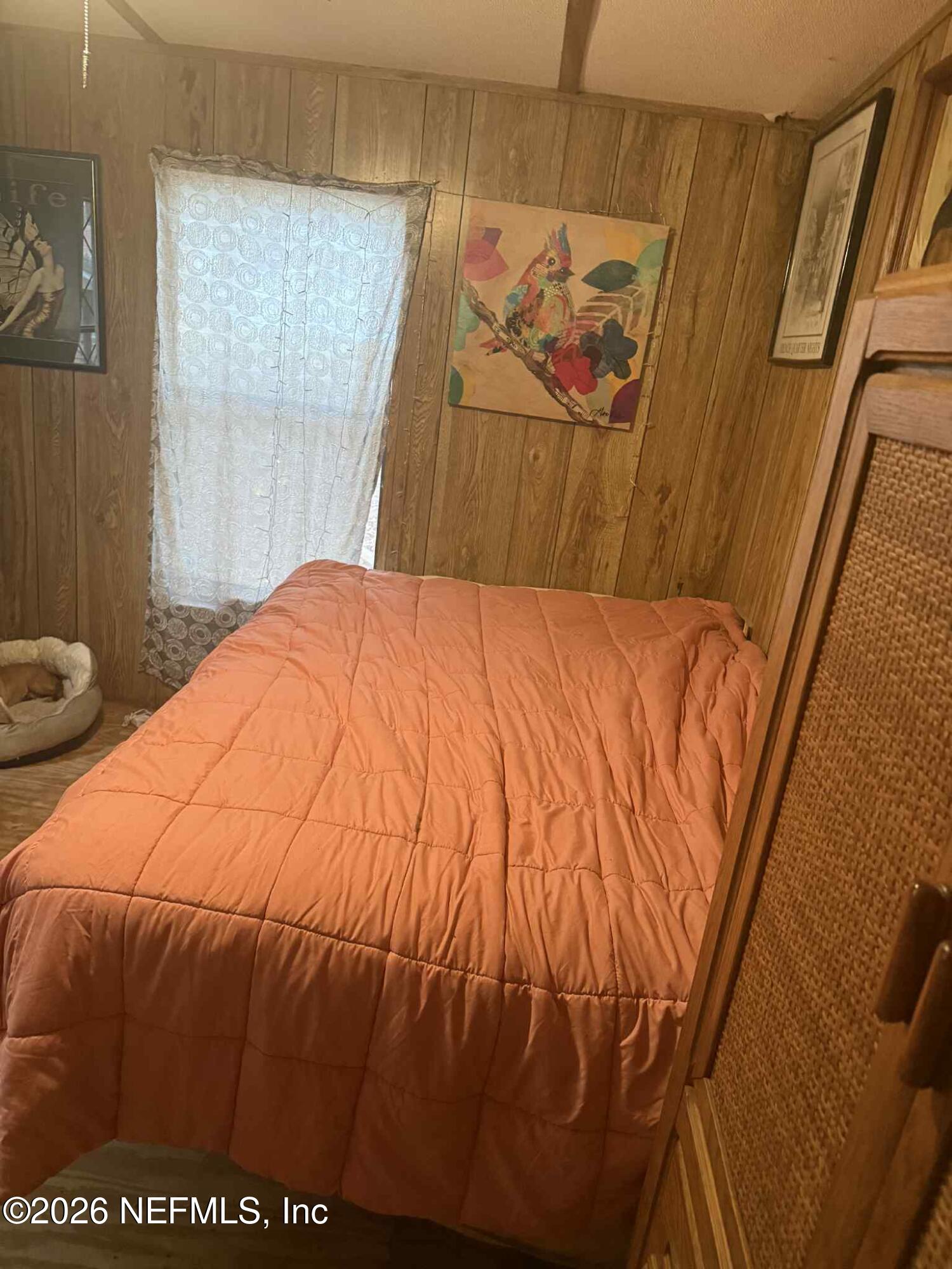 115 Chapel Lane Hawthorne, FL 32640 - Photo 19 of 23 a bedroom with a bed and a window