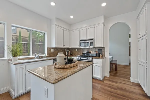 a kitchen with granite countertop lots of counter top space and dining table
