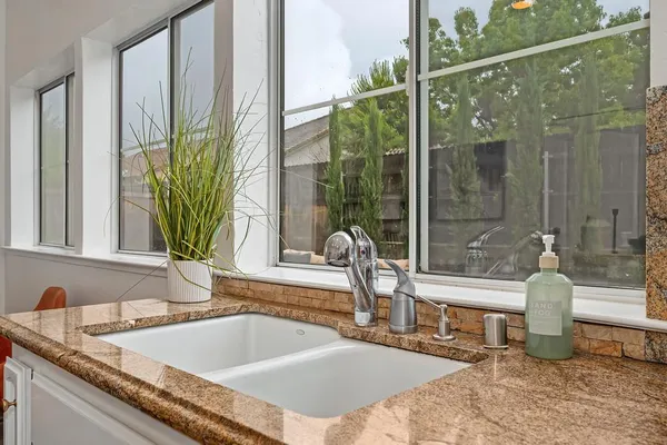 a bathroom with a sink a toilet and shower curtain