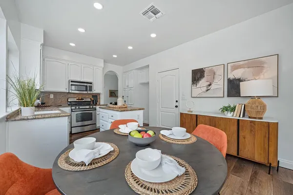 a view of a patio with couches and a table and chairs with garden view