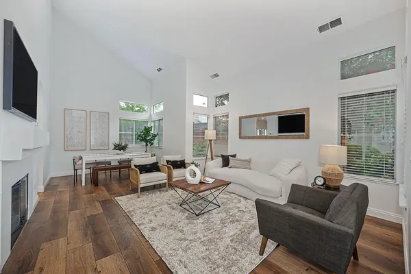 a living room with furniture wooden floor and a flat screen tv