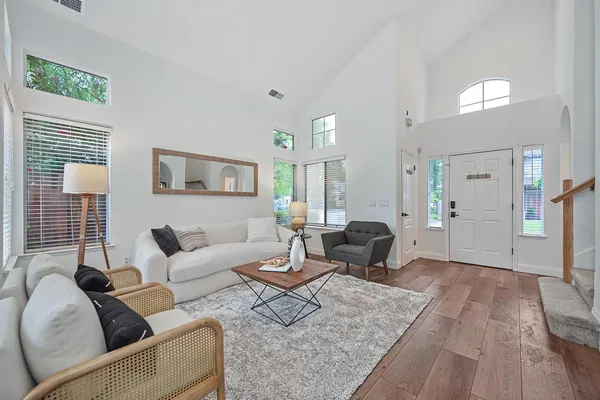 a living room with furniture and wooden floor