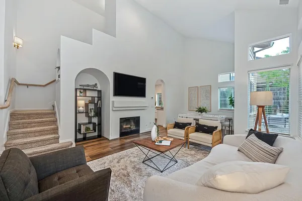 a living room with furniture a fireplace and a flat screen tv