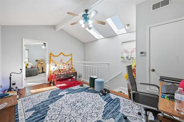 a living room with furniture gym equipment and a chandelier