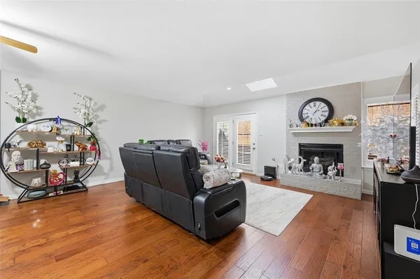 a living room with furniture a fireplace and a flat screen tv