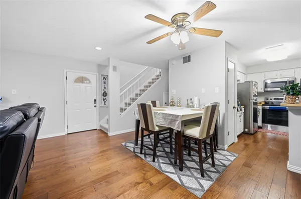 a view of a dining room with furniture and wooden floor