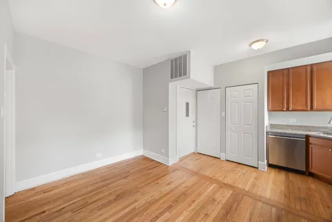 a view of a kitchen with wooden floor and a sink