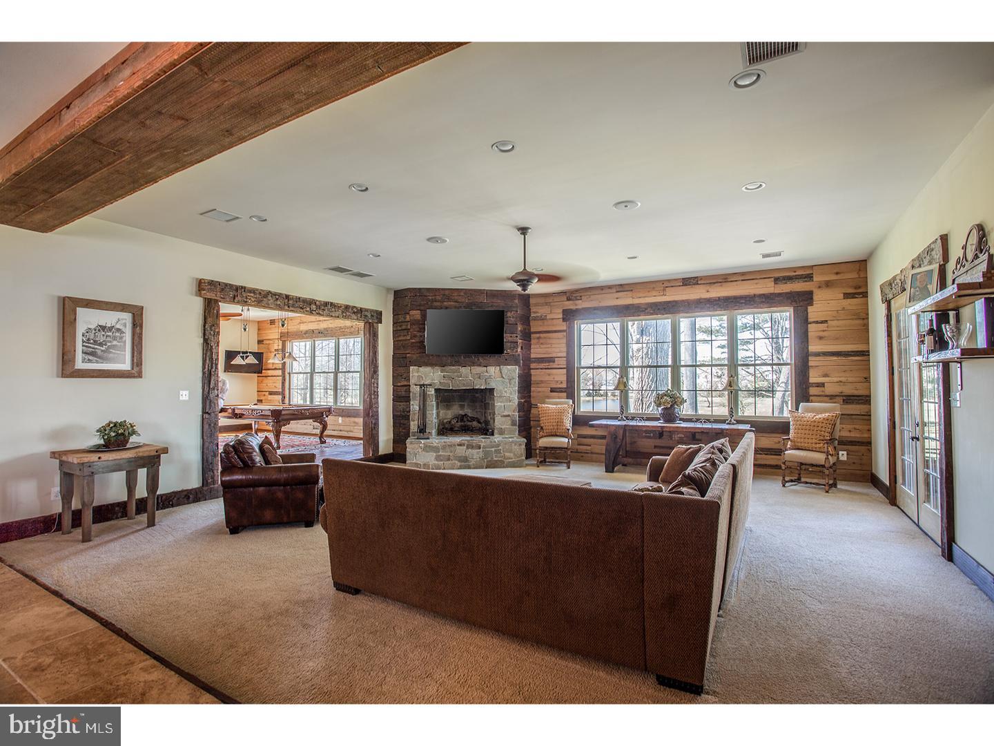 2103 Street Road New Hope, PA 18938 - Photo 11 of 25 a living room with furniture a large window and a flat screen tv