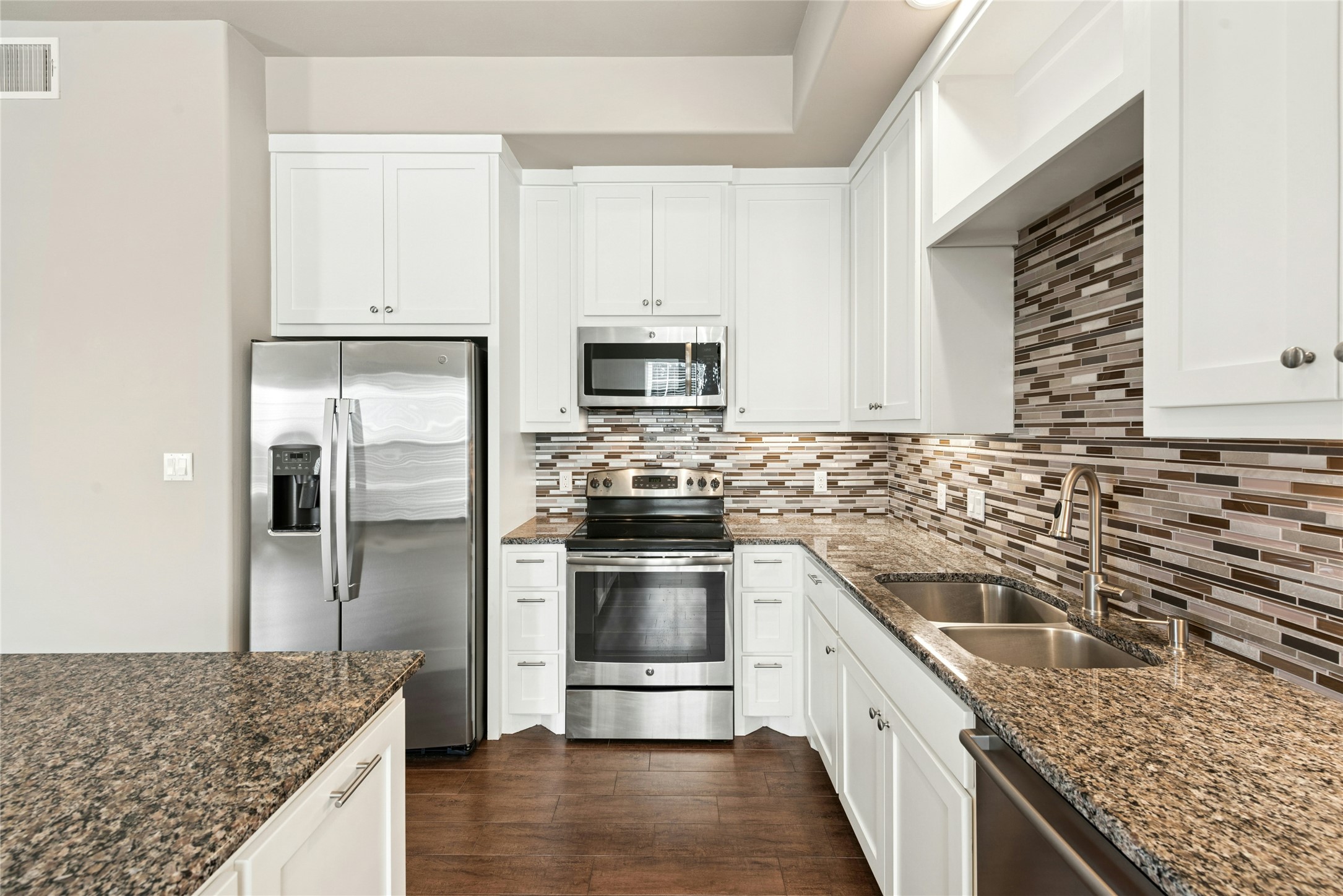 4301 Mansfield Dam Road, Unit 2101 Austin, TX 78734 - Photo 7 of 17 Kitchen featuring stainless steel appliances, white cabinets, and dark stone counters