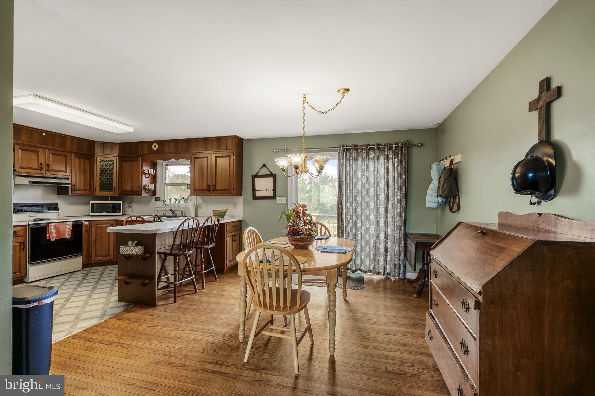 119 Harristown Road Paradise, PA 17562 - Photo 12 of 25 a kitchen with stainless steel appliances kitchen island granite countertop a table chairs sink and cabinets