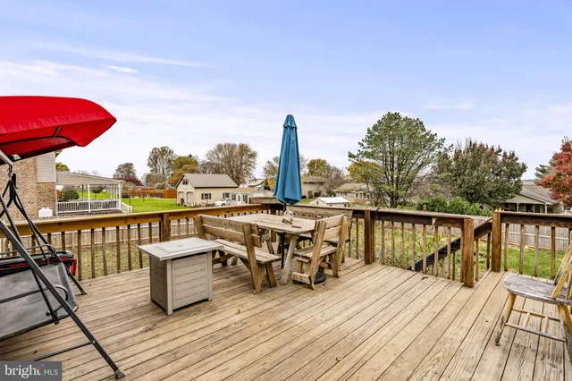 a view of a balcony with wooden floor and outdoor seating