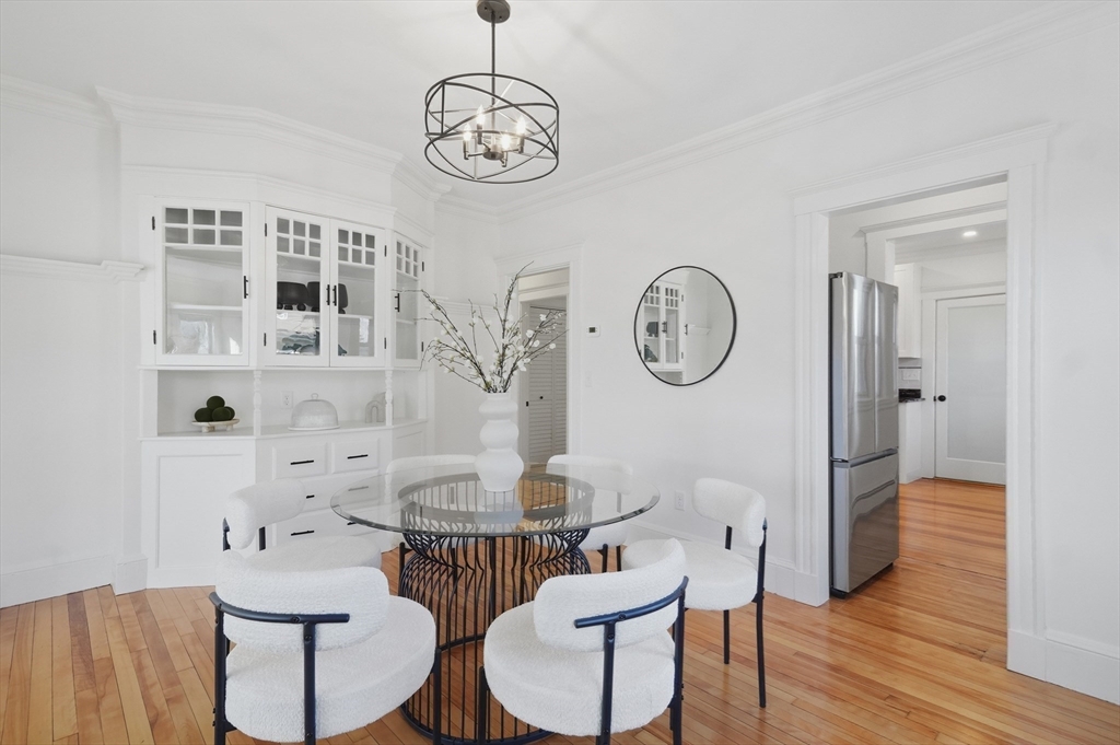 25 Spruce Street, Unit 25 Watertown, MA 02472 - Photo 11 of 39 a view of a dining room with furniture a chandelier and wooden floor