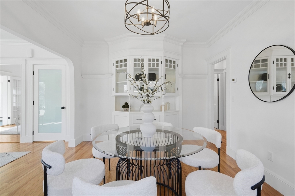 25 Spruce Street, Unit 25 Watertown, MA 02472 - Photo 12 of 39 a view of a dining room with furniture a chandelier and wooden floor