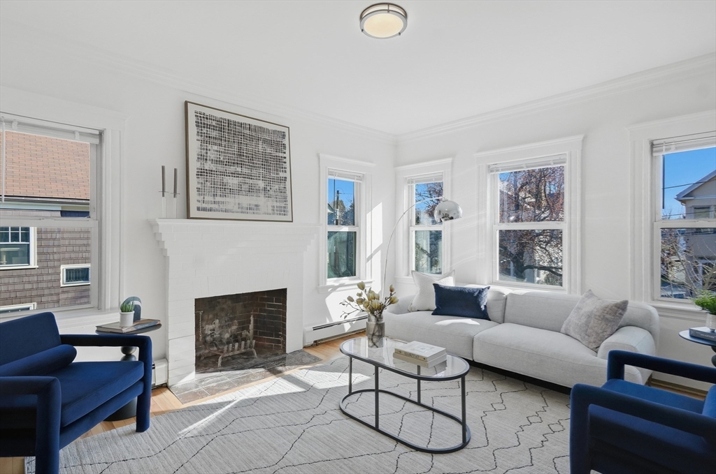 25 Spruce Street, Unit 25 Watertown, MA 02472 - Photo 15 of 39 a living room with furniture and a fireplace