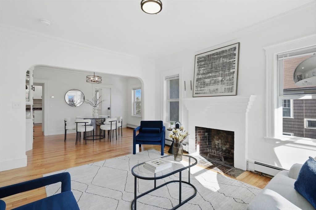 25 Spruce Street, Unit 25 Watertown, MA 02472 - Photo 16 of 39 a living room with furniture a fireplace and a table