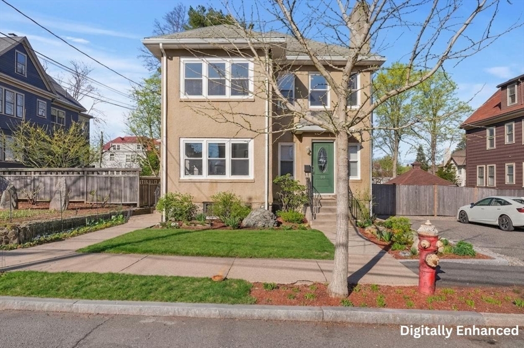 25 Spruce Street, Unit 25 Watertown, MA 02472 - Photo 2 of 39 a front view of a house with a yard