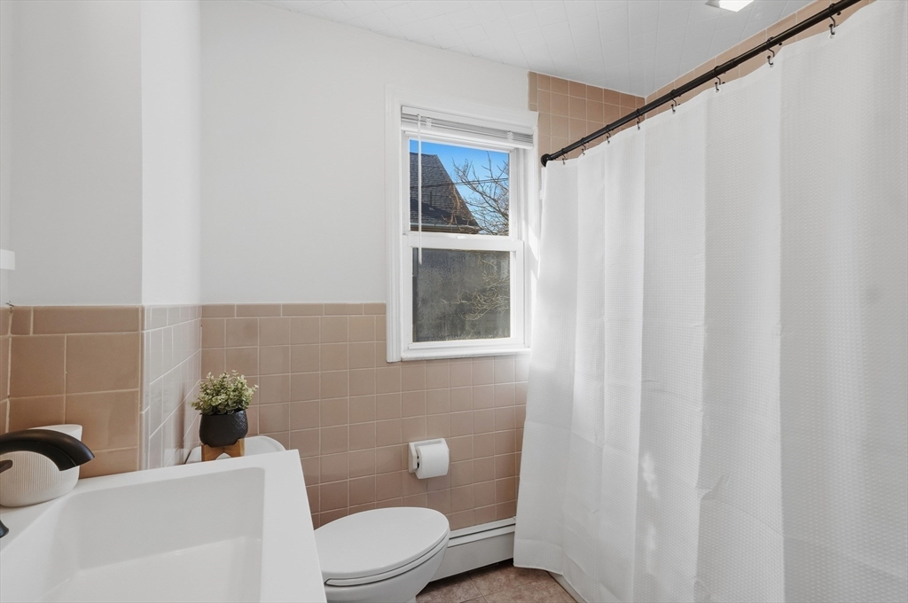 25 Spruce Street, Unit 25 Watertown, MA 02472 - Photo 23 of 39 a bathroom with a toilet a sink and a window