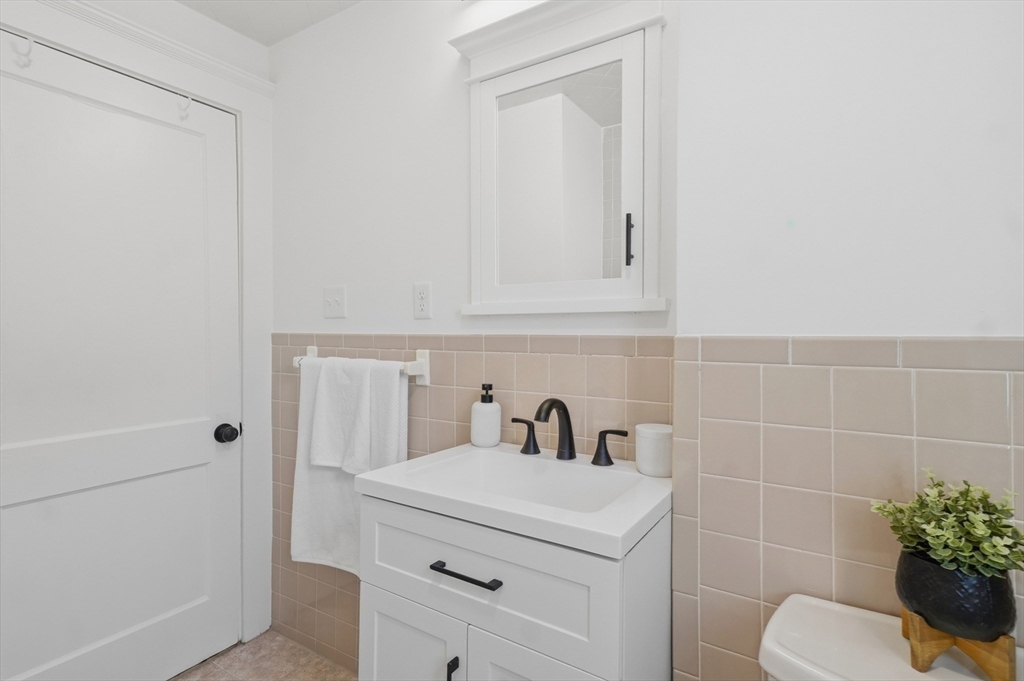 25 Spruce Street, Unit 25 Watertown, MA 02472 - Photo 24 of 39 a bathroom with a sink toilet and vanity