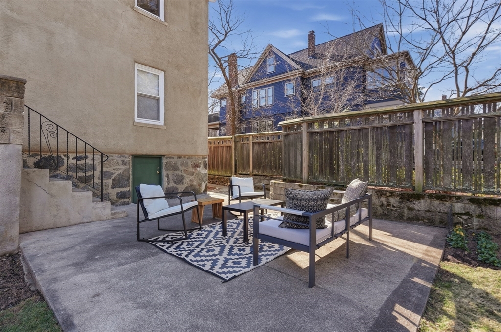 25 Spruce Street, Unit 25 Watertown, MA 02472 - Photo 30 of 39 a view of a patio with a table and chairs