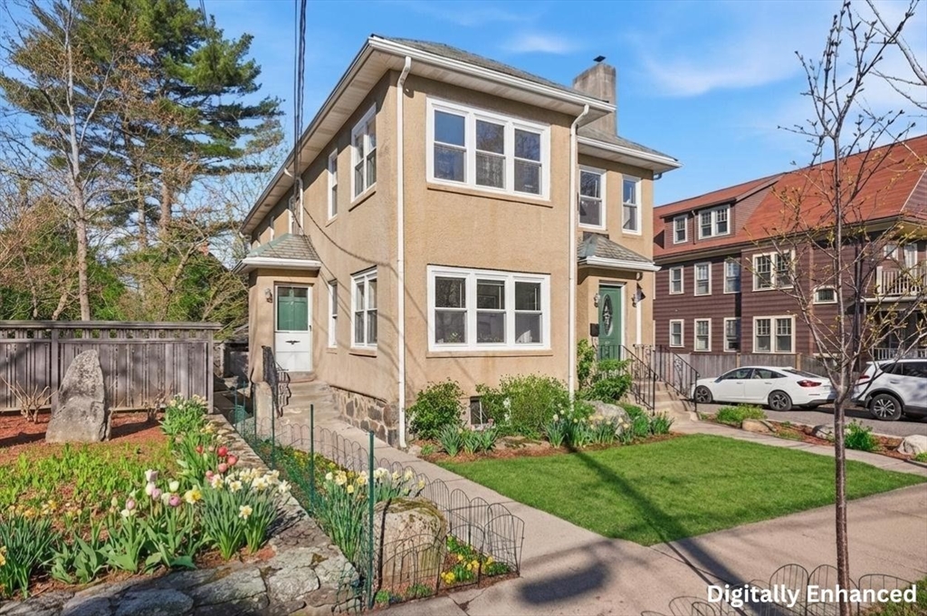 25 Spruce Street, Unit 25 Watertown, MA 02472 - Photo 3 of 39 a front view of a house with a yard table and chairs