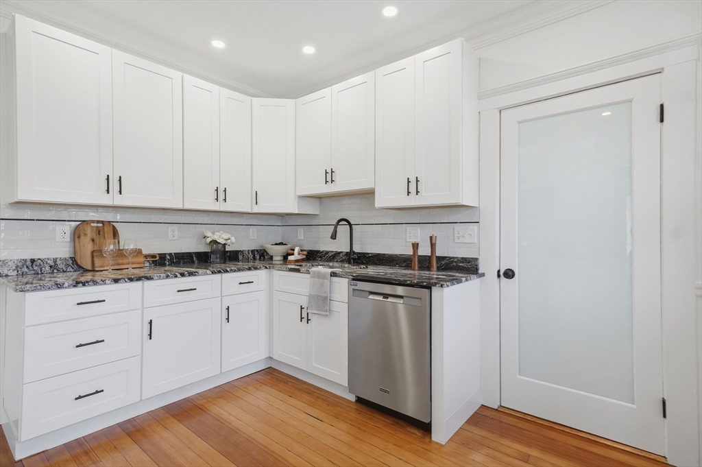25 Spruce Street, Unit 25 Watertown, MA 02472 - Photo 6 of 39 a kitchen with granite countertop white cabinets and sink