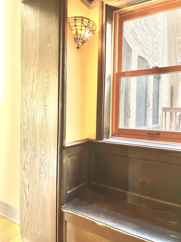a view of a hallway with wooden floor and a fireplace