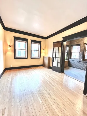 a view of an empty room with glass door