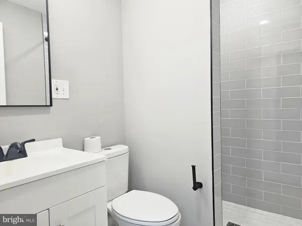 a bathroom with a toilet a sink and mirror