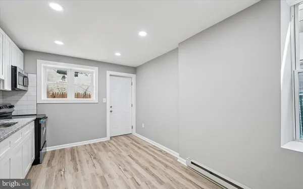 a view of room with window and wooden floor
