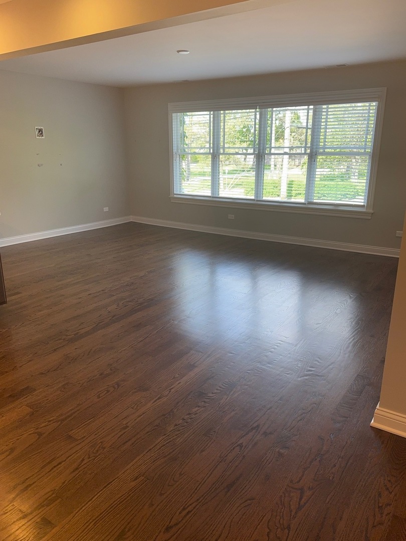 740 Chestnut Street, Unit 2 Deerfield, IL 60015 - Photo 11 of 11 an empty room with wooden floor and windows