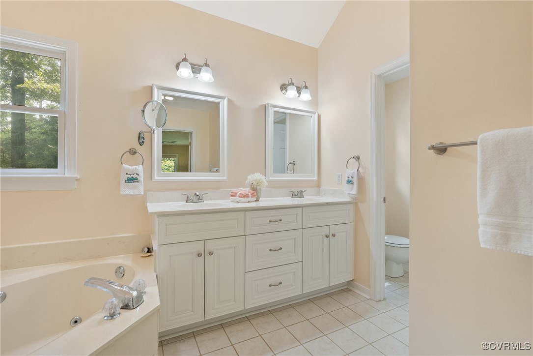 5311 Rock Harbour Road Midlothian, VA 23112 - Photo 26 of 49 a spacious bathroom with a double vanity sink a mirror and a bathtub