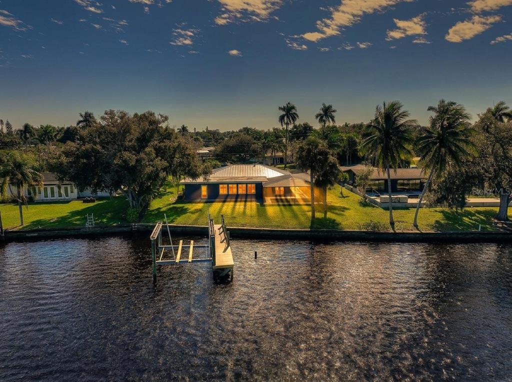 an aerial view of a house with swimming pool yard and outdoor seating