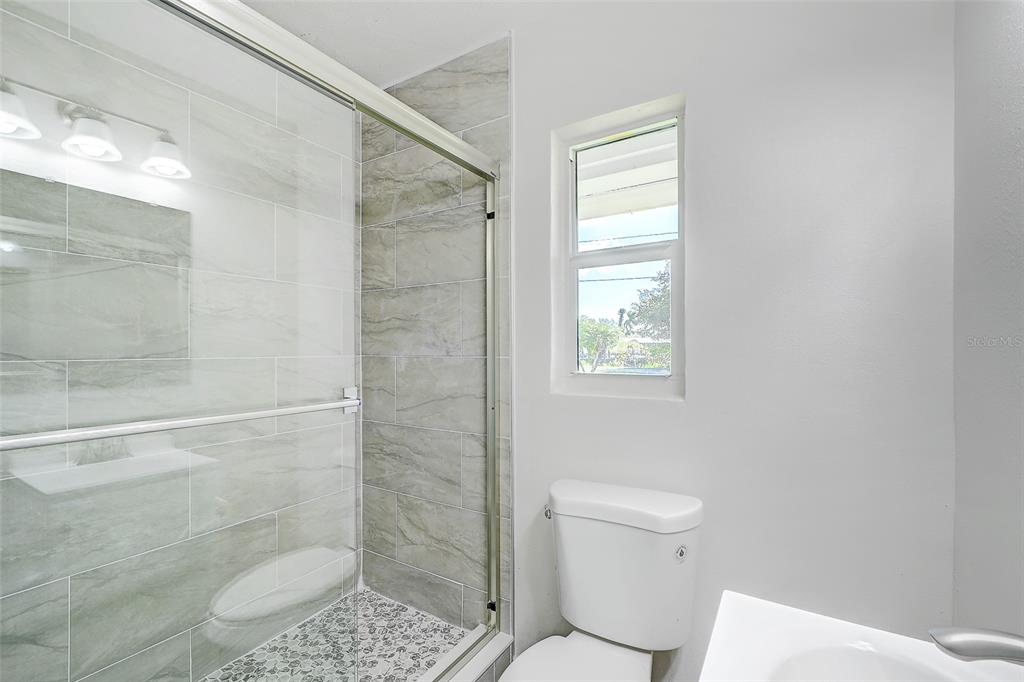 4867 East Riverside Drive Fort Myers, FL 33905 - Photo 24 of 45 a bathroom with a toilet and a shower