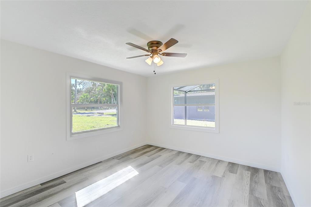4867 East Riverside Drive Fort Myers, FL 33905 - Photo 25 of 45 an empty room with a window and a ceiling fan