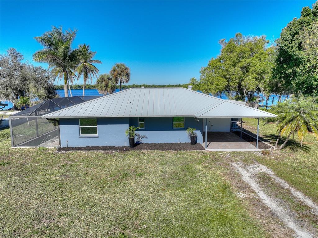 4867 East Riverside Drive Fort Myers, FL 33905 - Photo 4 of 45 a house that has a tree in front of it