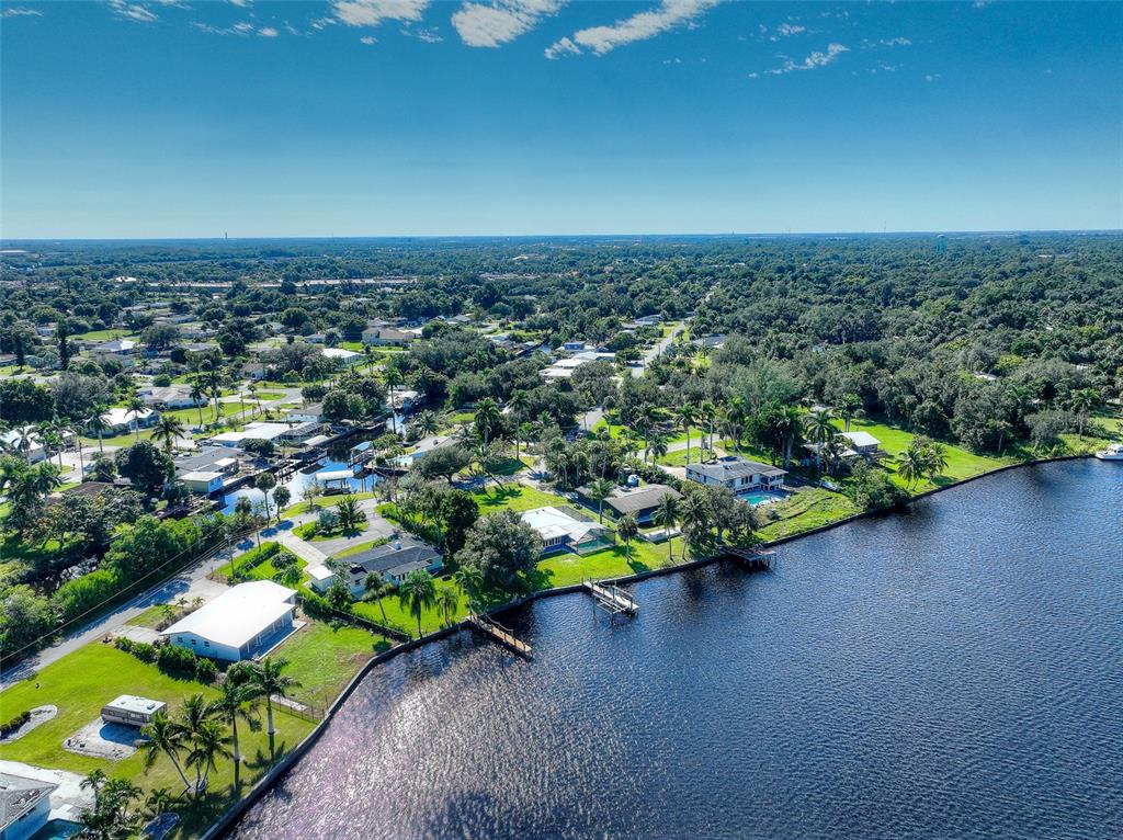 4867 East Riverside Drive Fort Myers, FL 33905 - Photo 42 of 45 an aerial view of a house with a yard and lake view