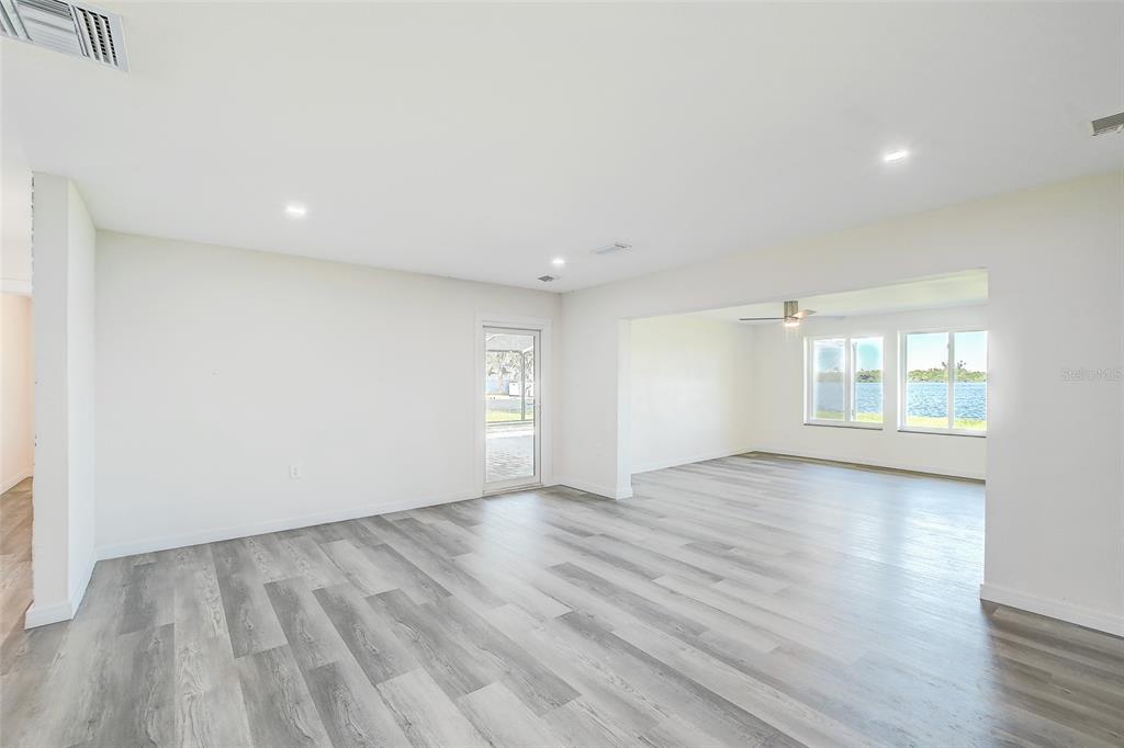 4867 East Riverside Drive Fort Myers, FL 33905 - Photo 7 of 45 wooden floor in an empty room with a window