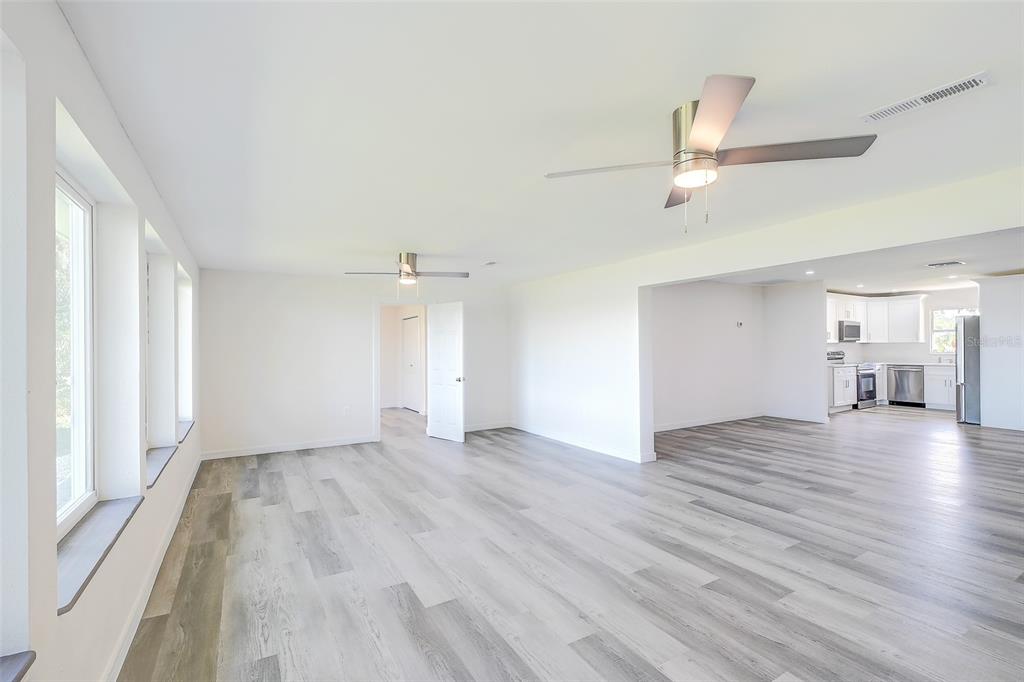 4867 East Riverside Drive Fort Myers, FL 33905 - Photo 10 of 45 an empty room with wooden floor and windows