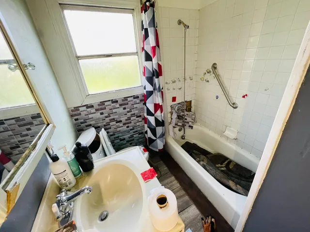 a bathroom with a sink mirror and toilet