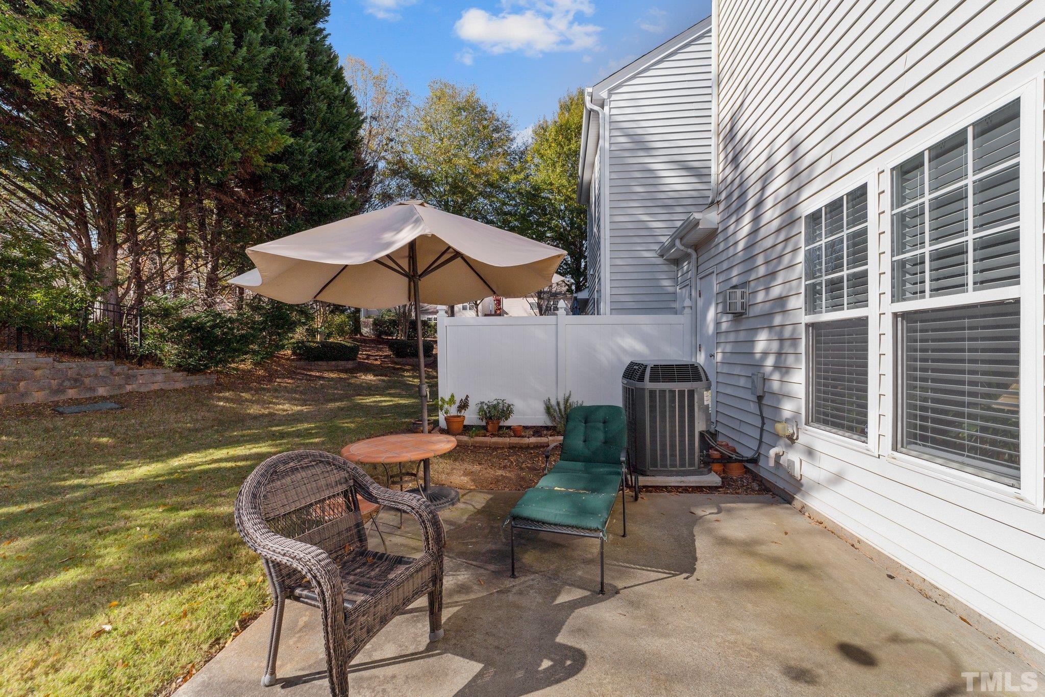 8405 Stoneyard Place Raleigh, NC 27613 - Photo 22 of 24 a patio with table and chairs under an umbrella