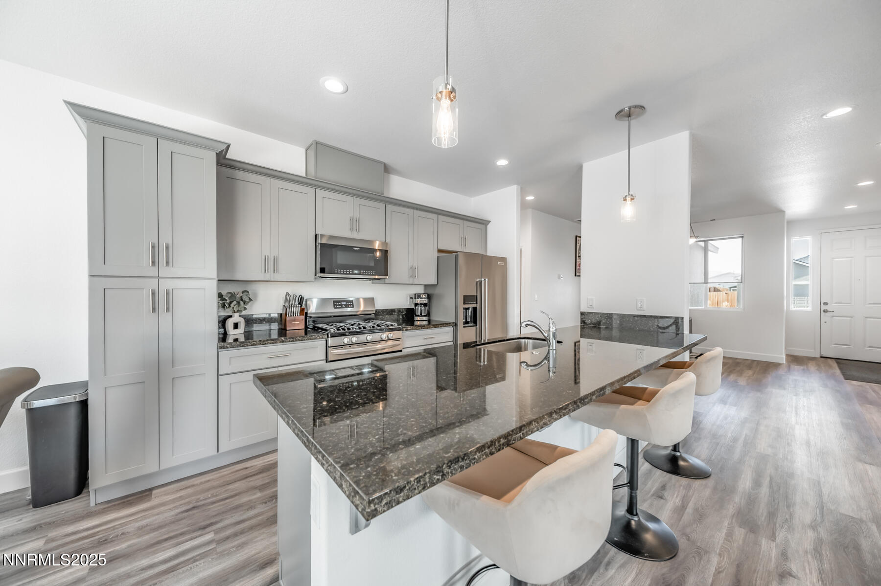 785 Garnet Way Fernley, NV 89408 - Photo 14 of 33 a kitchen with stainless steel appliances granite countertop a sink refrigerator and cabinets